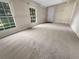 Living room with neutral carpeting and large windows at 828 Pinevalley Dr, Forest Park, GA 30297
