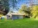Large backyard with lush green grass and mature trees at 828 Pinevalley Dr, Forest Park, GA 30297