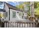 White cottage with deck and large tree in the yard at 3775 Clairmont Rd, Chamblee, GA 30341