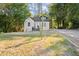 White house with front porch and grassy yard at 3775 Clairmont Rd, Chamblee, GA 30341