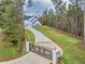 Curved driveway leading to a white two-story farmhouse at 1387 Mineral Springs Rd, Hoschton, GA 30548