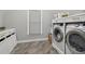 Convenient laundry room with side-by-side washer and dryer, and white cabinets at 3047 Players Dr, Jonesboro, GA 30236