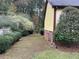 Landscaped side yard with mature shrubs and trees at 356 Sherwood Se Cir, Conyers, GA 30094