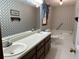 Bathroom with double vanity and patterned wallpaper at 356 Sherwood Se Cir, Conyers, GA 30094