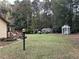 Large backyard with a shed, arbor, and landscaping at 356 Sherwood Se Cir, Conyers, GA 30094