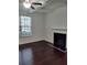 Living room with hardwood floors and a fireplace at 7736 Rutgers S Cir, Fairburn, GA 30213