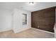 Bright bedroom featuring a large window and an accent wall at 7736 Rutgers S Cir, Fairburn, GA 30213