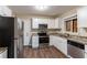 Renovated kitchen featuring white cabinets, granite counters, and stainless steel appliances at 2648 Cavalier Dr, Decatur, GA 30034