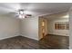 Open living room with vinyl flooring, a ceiling fan, and access to kitchen at 2648 Cavalier Dr, Decatur, GA 30034