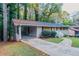 Ranch home with carport and driveway, surrounded by lush greenery at 2648 Cavalier Dr, Decatur, GA 30034