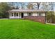 Charming ranch home with white siding and green lawn at 117 Neal Ave, Stockbridge, GA 30281