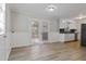 Eat-in kitchen with access to back deck and hardwood floors at 117 Neal Ave, Stockbridge, GA 30281
