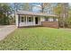 Recently updated ranch home with white exterior and a well manicured lawn at 117 Neal Ave, Stockbridge, GA 30281