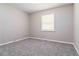 Spacious bedroom with neutral wall paint and grey carpet at 117 Neal Ave, Stockbridge, GA 30281