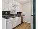 Updated kitchen with white cabinets, stainless steel appliances, and dark countertops at 117 Neal Ave, Stockbridge, GA 30281