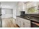 Kitchen features white cabinets, stainless steel appliances, and an eat-in area at 117 Neal Ave, Stockbridge, GA 30281
