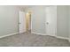 Bright bedroom with neutral walls, grey carpet, and a closet at 117 Neal Ave, Stockbridge, GA 30281