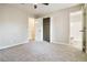 Bedroom with ceiling fan, grey carpet, and access to bathroom at 117 Neal Ave, Stockbridge, GA 30281