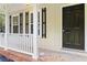 Inviting front porch with white railing and black front door at 117 Neal Ave, Stockbridge, GA 30281