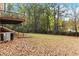 Sloping backyard with autumn leaves and trees at 117 Neal Ave, Stockbridge, GA 30281