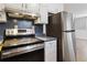 Stainless steel range and refrigerator in the kitchen at 117 Neal Ave, Stockbridge, GA 30281