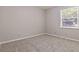 Simple bedroom with neutral wall paint and grey carpet at 117 Neal Ave, Stockbridge, GA 30281