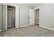 Bedroom with grey carpet, mirrored closet doors, and access to the hallway at 117 Neal Ave, Stockbridge, GA 30281