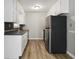 Galley kitchen with stainless steel appliances and white cabinets at 117 Neal Ave, Stockbridge, GA 30281