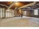 Unfinished basement area with exposed beams and large windows at 117 Neal Ave, Stockbridge, GA 30281