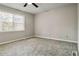 Bedroom with ceiling fan, neutral walls, and grey carpet at 117 Neal Ave, Stockbridge, GA 30281