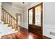 Bright entryway with hardwood floors and staircase at 9070 Twelvestones Dr, Roswell, GA 30076