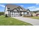 Two-story house, white and black exterior, landscaped lawn, and a driveway at 2635 Yellowstone Farm Dr, Cumming, GA 30028