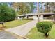 Ranch house with carport, showcasing curb appeal and landscaping at 6107 Phillip Ln, Lithonia, GA 30058