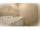 Laundry room with washer, dryer, and overhead shelving at 6687 Hill Creek Cv, Lithonia, GA 30058