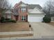 Brick two-story house with a large driveway and landscaped lawn at 102 Ozark Trl, Canton, GA 30114