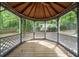 Interior view of the gazebo with wooden floor and screened walls at 1418 Branchwood Dr, Snellville, GA 30078