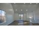 Living room with vaulted ceilings, multiple windows, and gray wood-look flooring at 7205 Jonsway, Cumming, GA 30041