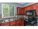 Kitchen features dark wood cabinets and a double sink at 149 Ellis Dr, Conyers, GA 30012