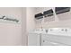 Bright laundry room with washer, dryer, and shelving at 106 Hampton Cir # 2, Mcdonough, GA 30253