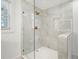 Walk-in shower with marble tile and gold fixtures at 1658 Hadlock Sw St, Atlanta, GA 30311