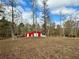 Red barn with white trim in a wooded area at 375 Campground Rd, Waco, GA 30182