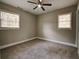 Well-lit bedroom with neutral walls, carpet, and two windows at 1072 Vincent Dr, Forest Park, GA 30297