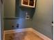 Laundry room with tile floors and built-in shelving at 2698 Claredon Nw Trce, Kennesaw, GA 30144