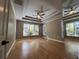 Large main bedroom with hardwood floors and multiple windows at 2698 Claredon Nw Trce, Kennesaw, GA 30144