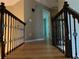 Elegant hallway with hardwood floors and ornate railing at 2698 Claredon Nw Trce, Kennesaw, GA 30144