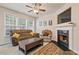 Cozy living room with fireplace, large screen TV and comfy seating at 3333 Castleberry Village Cir, Cumming, GA 30040