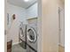 Bright laundry room with washer, dryer, and overhead cabinets at 3333 Castleberry Village Cir, Cumming, GA 30040