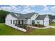 White farmhouse exterior with gray roof, landscaping, and a paved driveway at 3719 Tielman St, Snellville, GA 30078