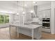 Modern kitchen with white cabinets, quartz countertops, and island at 3719 Tielman St, Snellville, GA 30078