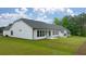 White house with gray roof, showcasing a large patio and backyard at 3719 Tielman St, Snellville, GA 30078